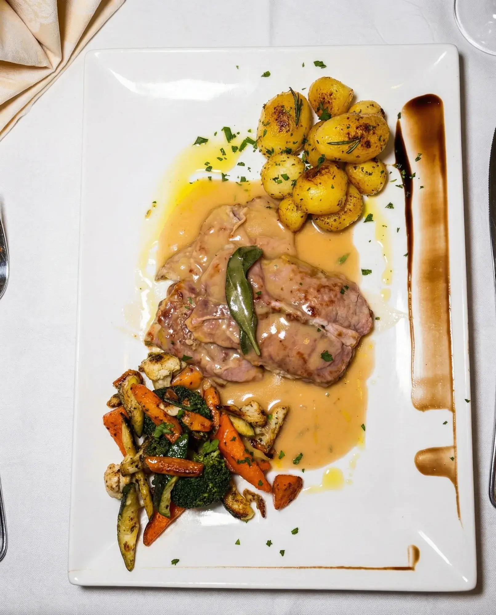 Saltimbocca mit Rosmarinkartoffeln und Gemüse bei La Commedia.